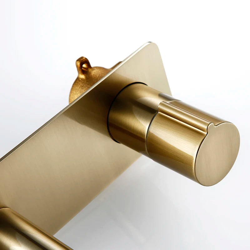 Brushed gold wall mounted basin tap fitting detail