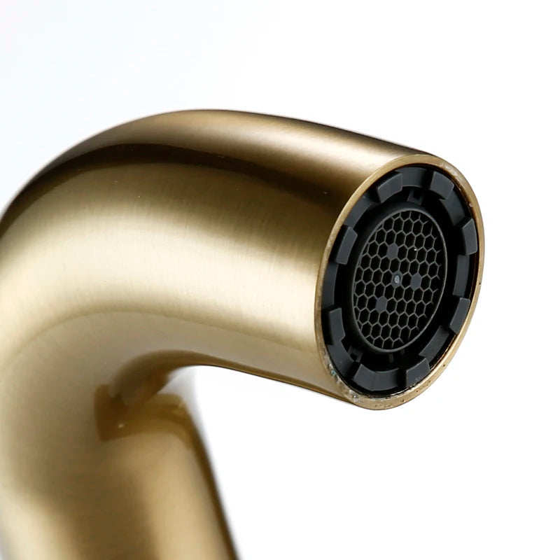 Brushed gold wall mounted basin tap close-up